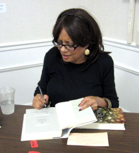 Deborah Johnson signs The Secret of Magic.  Photo by Nancy Jacobs. 