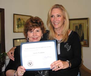 Moe Jackson and Nanette Workman display certificate from Governor Haley Barbour