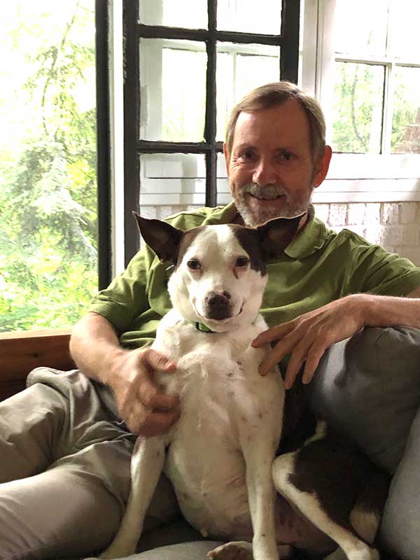 Author Evan Peacock sitting with this dog